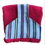 Hand towel to hang on a kitchen or Aga rail. Fastened with magnetic popper. Red towel. Towel top cream with bold stripes of yellow, red, orange, green, blue. Pattern placing varies the coloured stripes.