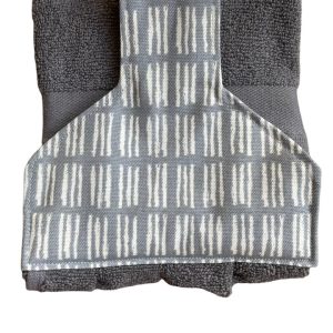 Hand towel to hang on a rail. Fastened with magnetic popper. Towel charcoal grey. Towel top grey/white geometric design.
