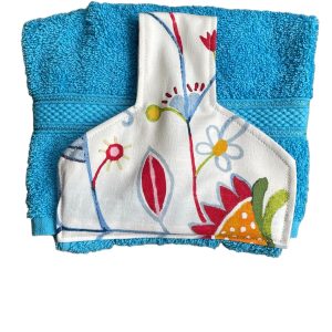 Hand towel to hang on kitchen or Aga rail. Fastened with a magnetic popper. Towel turquoise blue. Top off white with multicloured abstract flower design.
